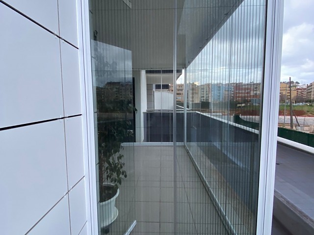Balcony enclosure with glass curtain